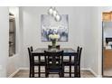 Dining room featuring wood floors, a modern chandelier, and seating for four at 7375 S Alkire St # 102, Littleton, CO 80127