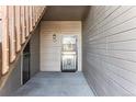 Exterior view of the unit's front door with security screen at 7375 S Alkire St # 102, Littleton, CO 80127