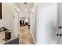 Bright hallway leading to the living room with wood floors and a coat closet at 7375 S Alkire St # 102, Littleton, CO 80127