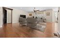 Bright living room features hardwood floors, neutral walls, and a ceiling fan at 6420 Agave Ave, Castle Rock, CO 80108