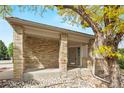Inviting front porch with brick pillars and stone accents, offering a warm welcome to the home at 9432 La Quinta Way, Lone Tree, CO 80124