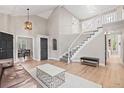 Spacious living area with staircase, hardwood floors, and neutral color palette at 9432 La Quinta Way, Lone Tree, CO 80124
