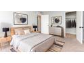 Comfortable bedroom with neutral tones, carpeted floor and ample closet space at 10722 E Exposition Ave # 314, Aurora, CO 80012