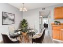 Cozy dining area with a glass table and modern chandelier at 10722 E Exposition Ave # 314, Aurora, CO 80012