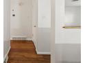 Bright hallway with wood floors, white walls, and minimalist trim, leading to other rooms at 945 Emerald St, Broomfield, CO 80020