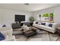 Bright living room with a large window, modern furnishings, and stylish decor at 945 Emerald St, Broomfield, CO 80020