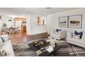 Open-concept living room featuring hardwood floors, natural light, and stylish decor at 945 Emerald St, Broomfield, CO 80020