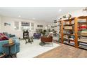 Bright living room with comfy seating and built-in shelving at 11368 Lamar St, Westminster, CO 80020