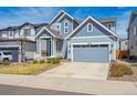 Inviting curb appeal of this two-story home with a two-car garage and driveway at 27837 E 8Th Ave, Aurora, CO 80018