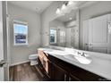 Modern bathroom with double vanity and a shower/tub combo at 12785 Horton Ct, Parker, CO 80134