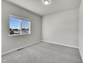 Simple bedroom with grey carpet and a window with a view at 12785 Horton Ct, Parker, CO 80134