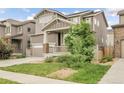 Charming two-story home with a two-car garage, inviting front porch and landscaped front yard at 6484 N Ceylon Ct, Denver, CO 80249
