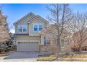 Charming two-story home with a two-car garage and well-maintained lawn at 9978 Salida St, Commerce City, CO 80022