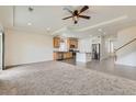 Open-concept living area featuring plush carpeting, recessed lighting, and seamlessly flowing into the modern kitchen at 12853 E 108Th Ave, Commerce City, CO 80022