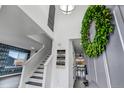 Welcoming foyer with soaring ceilings, modern decor, and an open staircase to the upper level at 7132 Eagle Rock Dr, Littleton, CO 80125