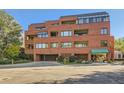 Brick building exterior with parking and landscaping at 624 Pearl St # 301, Boulder, CO 80302