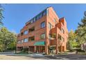 Brick building exterior with parking and landscaping at 624 Pearl St # 301, Boulder, CO 80302