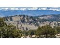 Scenic mountain vista with snow-capped peaks, showcasing the home's stunning location and natural beauty at 401 Raptor Point Rd, Golden, CO 80403