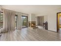 Spacious living room with a charming fireplace, balcony access and a piano at 22453 Hillcrest Cir, Golden, CO 80401