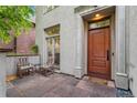 Inviting front entrance with seating area and a classic wooden door with stone trim at 635 N Williams St, Denver, CO 80218