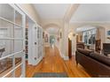 Open foyer with hardwood floors, arched doorways, and an inviting view into the living spaces at 635 N Williams St, Denver, CO 80218