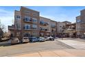 Modern condo building featuring balconies, assigned parking, and an attractive neutral color palette at 5677 S Park Pl # A110, Greenwood Village, CO 80111