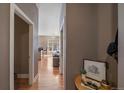 Inviting hallway leading to a living area with wood floors, an open floor plan, and natural light at 5677 S Park Pl # A110, Greenwood Village, CO 80111