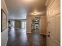Bright living room showcasing the open layout into the kitchen and a cozy fireplace at 12208 W Dorado Pl # 207, Littleton, CO 80127