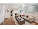 Bright living room with hardwood floors, modern furniture, and ample natural light from large windows at 1236 N Tennyson St, Denver, CO 80204