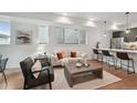 Cozy living room with stylish seating, a modern fireplace, and an adjacent kitchen area with bar seating at 1236 N Tennyson St, Denver, CO 80204