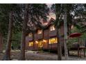 Beautiful wood home nestled among tall trees, creating a serene and private mountain retreat at 592 Brook Dr, Idaho Springs, CO 80452