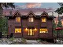 Inviting wood-clad home featuring large windows and a charming entrance, perfect for mountain living at 592 Brook Dr, Idaho Springs, CO 80452