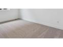 Neutral bedroom featuring cozy carpet and ample natural light at 8607 Yellowcress St, Littleton, CO 80125