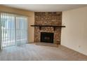 Inviting living room featuring a striking stone fireplace and sliding glass door at 8335 Fairmount Dr # 8-206, Denver, CO 80247