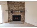 Inviting living room featuring a striking stone fireplace at 8335 Fairmount Dr # 8-206, Denver, CO 80247