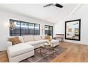 Bright living area with large windows, hardwood flooring, and elegant chandelier at 1065 S Monroe St, Denver, CO 80209