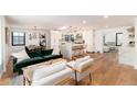 Open-concept living and dining area with hardwood floors and modern finishes at 1065 S Monroe St, Denver, CO 80209