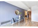 Cozy dining area with wood floors, stylish table, and a view into the hallway at 555 E 10Th Ave # 111, Denver, CO 80203