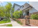 Charming building exterior with brick accents, manicured landscaping and inviting entrance at 555 E 10Th Ave # 111, Denver, CO 80203