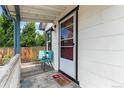 Welcoming front porch with chairs, offering a cozy space to relax and enjoy the neighborhood views at 2896 Depew St, Wheat Ridge, CO 80214