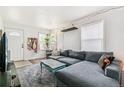 Comfortable living room featuring a large gray sectional sofa and ample natural light at 2896 Depew St, Wheat Ridge, CO 80214