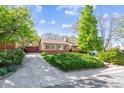 Inviting home with a brick exterior, manicured lawn, mature trees and a paved driveway at 9301 Ciancio St, Thornton, CO 80229