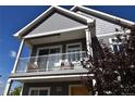 A beautiful balcony provides a relaxing outdoor retreat with seating, perfect for enjoying the neighborhood views at 17747 E 54Th Ave, Denver, CO 80249