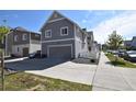 Well-maintained home featuring a gray exterior, two-car garage, and charming landscaping in a desirable neighborhood at 17747 E 54Th Ave, Denver, CO 80249