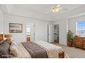 Bright main bedroom featuring a walk-in closet, dresser, and ensuite bathroom at 51 W 6Th Pl, Byers, CO 80103