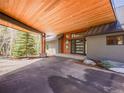 Home exterior displaying covered parking with stylish wood accents and architectural details at 34089 Woodland Dr, Evergreen, CO 80439