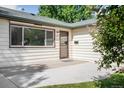 Close-up of home's entrance with a tidy porch, and a charming front door at 5167 S Pearl St, Littleton, CO 80121