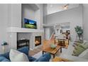 Bright living room featuring a modern fireplace, high ceilings, and a comfortable seating arrangement at 14300 Waterside Ln # E3, Broomfield, CO 80023