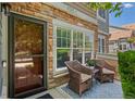 Inviting front porch with chairs, creating a cozy outdoor seating area with stone accents at 14300 Waterside Ln # E3, Broomfield, CO 80023