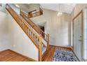 Elegant entryway featuring a staircase, hardwood floors, and modern lighting at 10941 Parker Vista Rd, Parker, CO 80138
